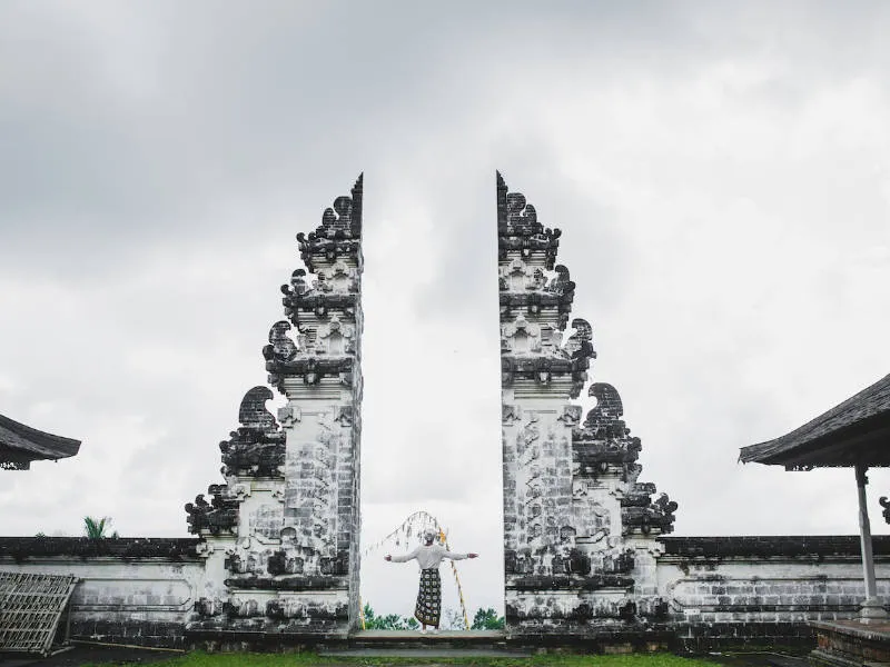 a person posing in between the gates of the Lempuyang Temple