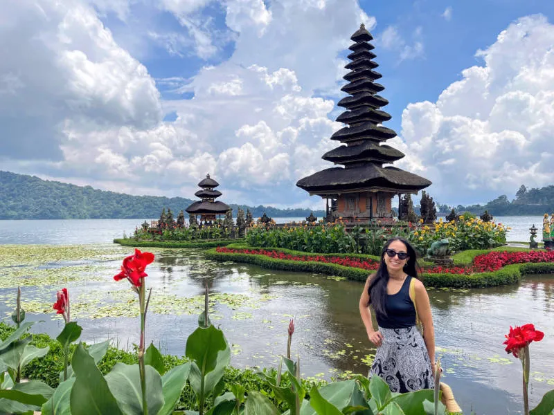 a girl posing before the Ulun Danu Beratan Temple